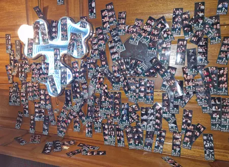Mur de tirages photo laissés par les clients du Pub La Fayette